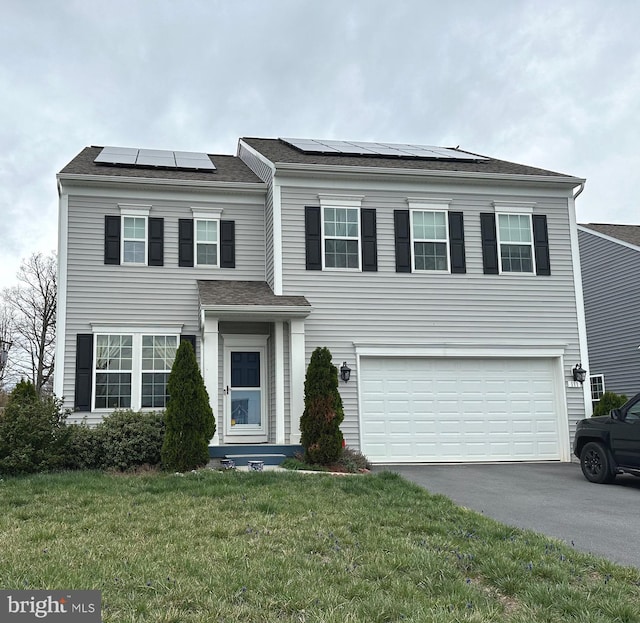 111 Sovereign Ct, Winchester, VA 22602 - traditional-style house with a front lawn, solar panels, driveway, roof with shingles, and a garage