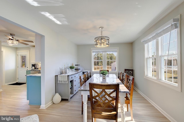 20938 Olen Mattingly Rd, Avenue, MD 20609 - dining room with ceiling fan with notable chandelier, baseboards, and light wood-type flooring