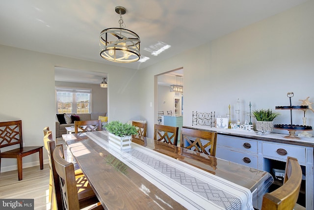 20938 Olen Mattingly Rd, Avenue, MD 20609 - dining room featuring baseboards, light wood-type flooring, and ceiling fan with notable chandelier