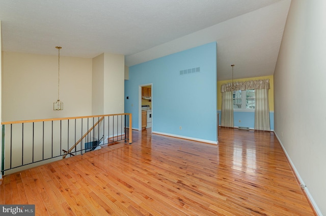 2943 Strathaven Ln, Abingdon, MD 21009 - unfurnished room featuring a chandelier, wood-type flooring, and lofted ceiling