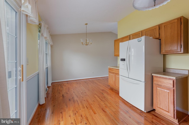 2943 Strathaven Ln, Abingdon, MD 21009 - kitchen featuring white fridge with ice dispenser, lofted ceiling, light wood finished floors, a chandelier, and light countertops