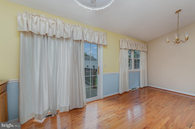 2943 Strathaven Ln, Abingdon, MD 21009 - unfurnished room with a chandelier, light wood-style floors, and vaulted ceiling