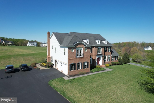 15841 Seneca Run Ct, Darnestown, MD 20874 - view of front facade with a front lawn, driveway, a chimney, brick siding, and a garage