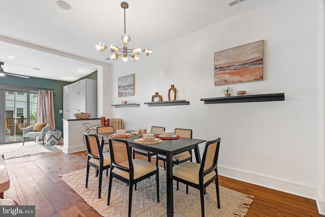 dining space with a chandelier, wood finished floors, baseboards, ceiling fan, and recessed lighting