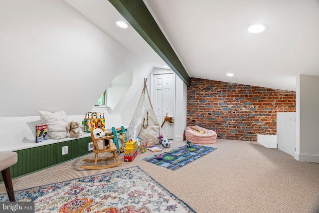recreation room featuring brick wall, vaulted ceiling, carpet flooring, and recessed lighting