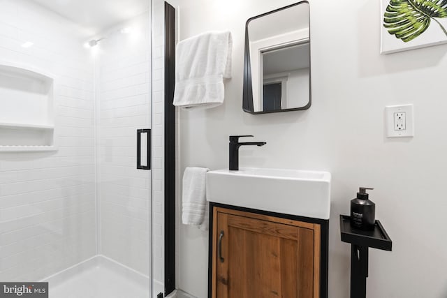 full bath with a stall shower and vanity