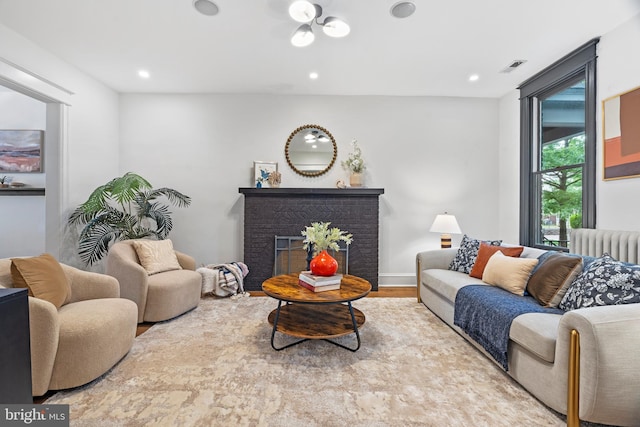 living room featuring radiator, recessed lighting, wood finished floors, and a fireplace