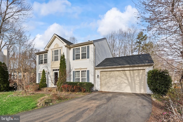 view of front of home with driveway and a garage