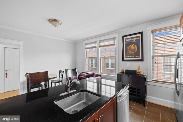 3024 Wisconsin Ave NW Unit 208, Washington, DC 20016 - kitchen featuring stainless steel appliances, a sink, crown molding, plenty of natural light, and baseboards