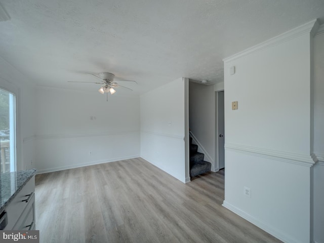 1566 Lodge Pole Ct, Annapolis, MD 21409 - spare room featuring light wood-style floors, baseboards, ceiling fan, and stairway