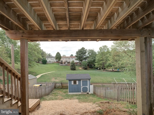 1566 Lodge Pole Ct, Annapolis, MD 21409 - view of yard featuring a storage unit, a fenced backyard, and an outbuilding