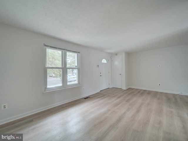 1566 Lodge Pole Ct, Annapolis, MD 21409 - unfurnished living room with visible vents, light wood-style flooring, and baseboards