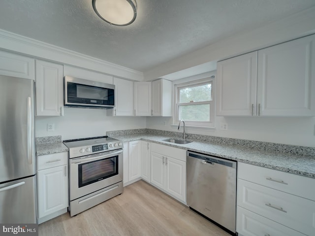 1566 Lodge Pole Ct, Annapolis, MD 21409 - kitchen with a sink, white cabinets, stainless steel appliances, and a textured ceiling