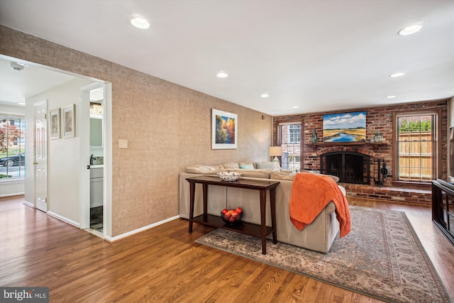 living area featuring wood finished floors, a fireplace, baseboards, and recessed lighting