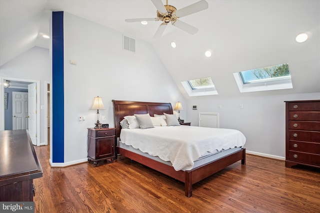 bedroom featuring dark wood-style flooring, visible vents, baseboards, and vaulted ceiling with skylight