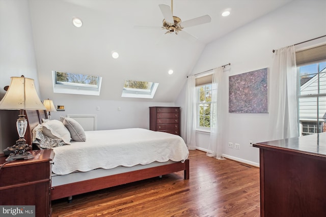 bedroom featuring vaulted ceiling with skylight, ceiling fan, recessed lighting, wood finished floors, and baseboards