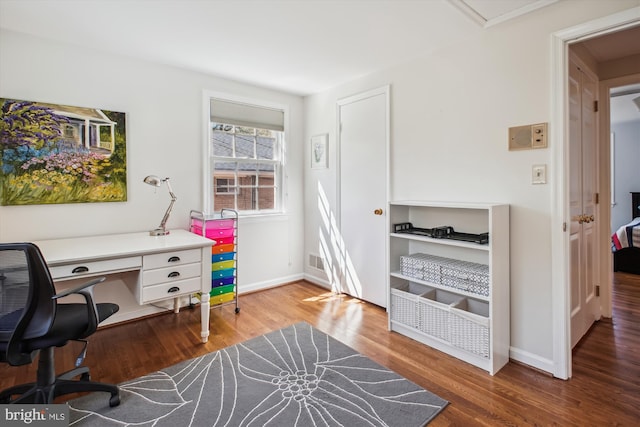 home office with visible vents, baseboards, and wood finished floors