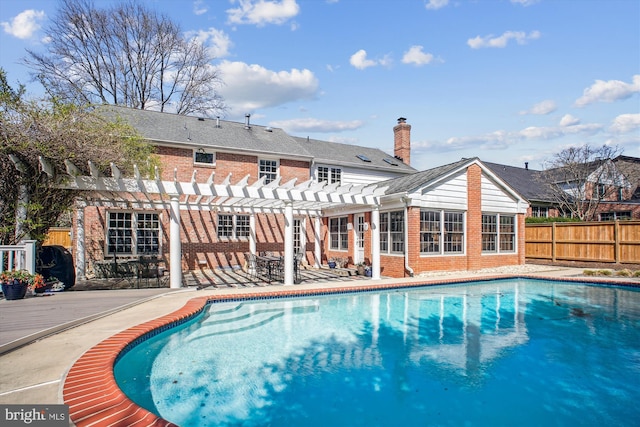 view of swimming pool with a patio, a pergola, a fenced in pool, and fence