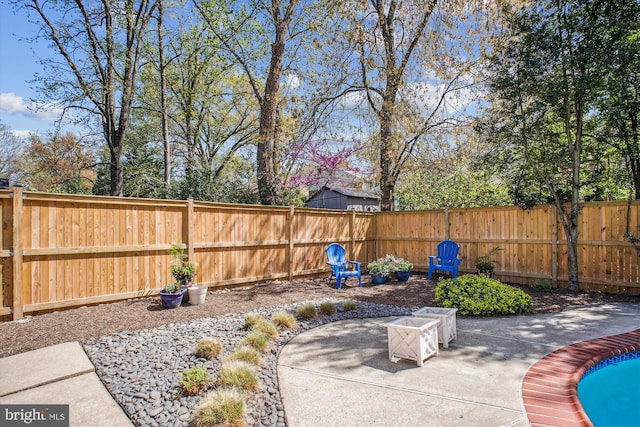 view of patio / terrace featuring a swimming pool and a fenced backyard