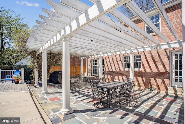 view of patio / terrace with outdoor dining area, a pergola, and fence