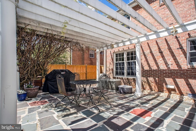 view of patio featuring area for grilling, outdoor dining area, a pergola, and fence