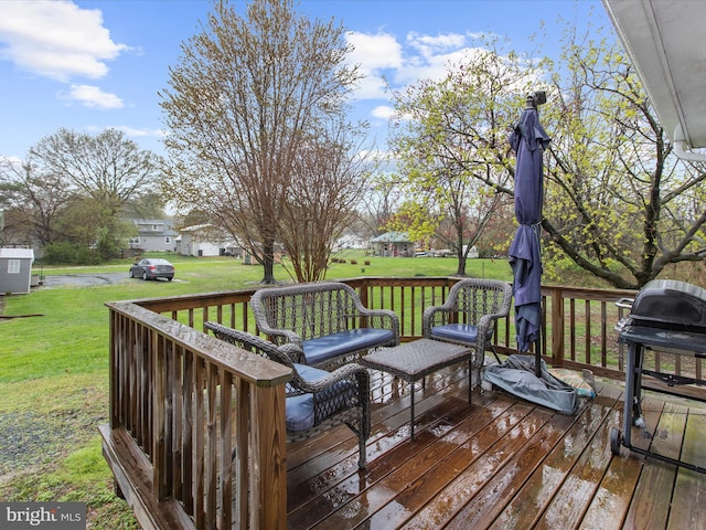 deck featuring a yard and grilling area