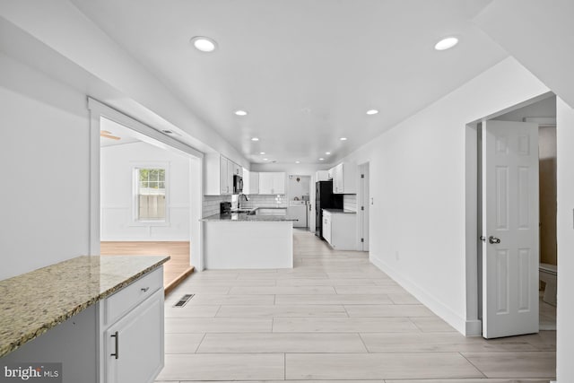 kitchen featuring white cabinets, recessed lighting, visible vents, and black appliances