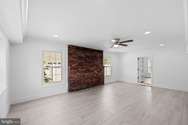 unfurnished living room featuring baseboards, ceiling fan, light wood finished floors, and recessed lighting
