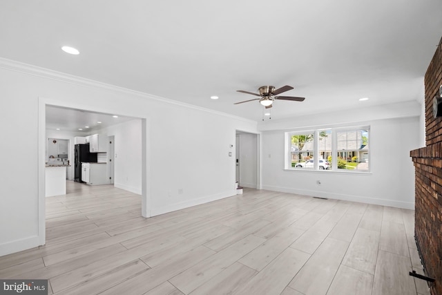 unfurnished living room featuring crown molding, a ceiling fan, baseboards, and recessed lighting