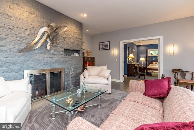 living room with a fireplace, wood finished floors, baseboards, and recessed lighting