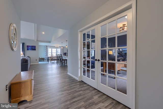 hall featuring baseboards, vaulted ceiling with beams, wood finished floors, and french doors