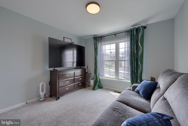 sitting room with carpet floors, baseboards, and visible vents