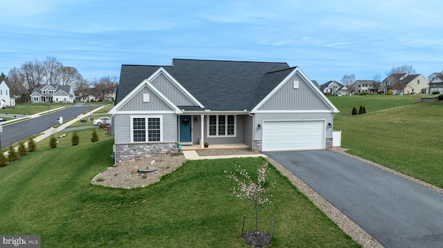 view of front of house with stone siding, an attached garage, board and batten siding, aphalt driveway, and a shingled roof