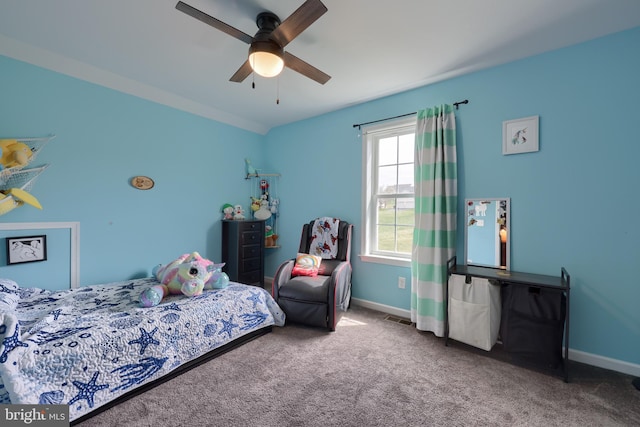 bedroom featuring baseboards, carpet flooring, visible vents, and a ceiling fan