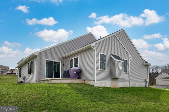 back of property featuring a yard