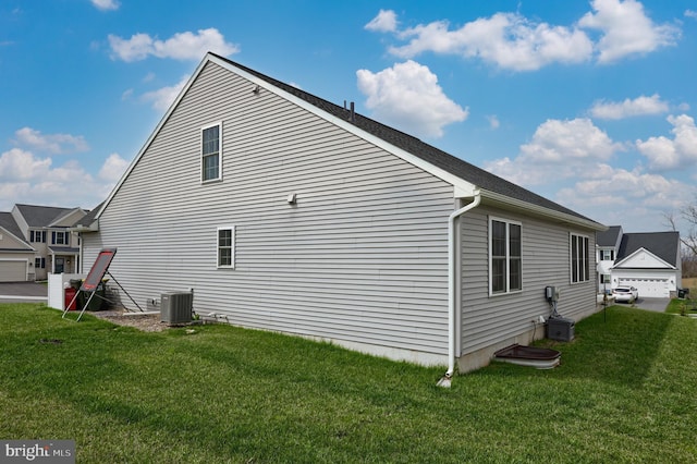 view of home's exterior featuring cooling unit and a yard