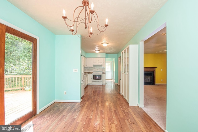 302 Parkside Rd, Linden, VA 22642 - unfurnished dining area featuring healthy amount of natural light, wood finished floors, a chandelier, baseboards, and a textured ceiling
