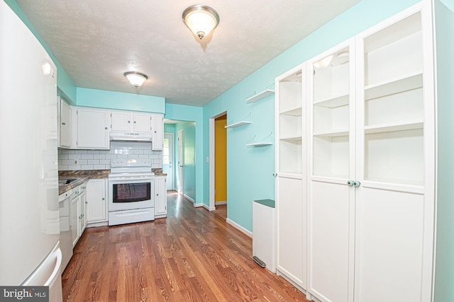 302 Parkside Rd, Linden, VA 22642 - kitchen featuring white appliances, white cabinets, under cabinet range hood, backsplash, and dark wood-style floors