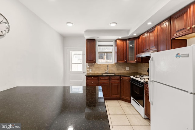 2225 S Hicks St, Philadelphia, PA 19145 - kitchen with range with gas cooktop, under cabinet range hood, a sink, light tile patterned floors, and freestanding refrigerator