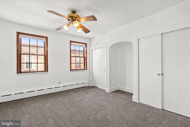 2225 S Hicks St, Philadelphia, PA 19145 - unfurnished bedroom featuring baseboard heating, two closets, carpet flooring, and a textured ceiling