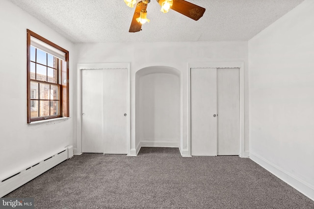 2225 S Hicks St, Philadelphia, PA 19145 - unfurnished bedroom with a textured ceiling, carpet flooring, two closets, and baseboard heating