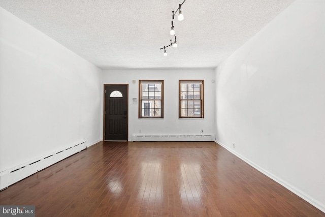 2225 S Hicks St, Philadelphia, PA 19145 - entryway with a baseboard radiator, a textured ceiling, and hardwood / wood-style floors