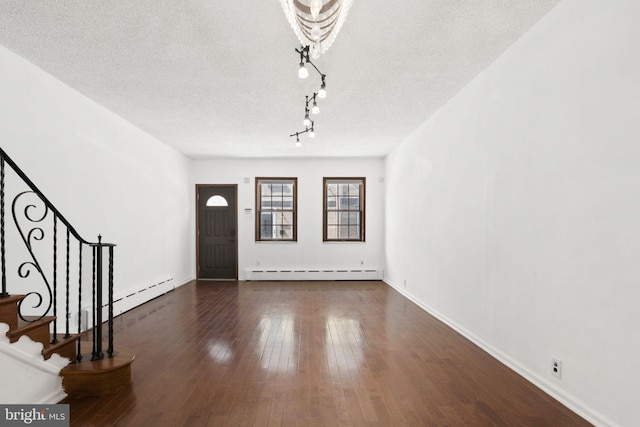 2225 S Hicks St, Philadelphia, PA 19145 - foyer entrance with a baseboard radiator, a textured ceiling, stairs, and hardwood / wood-style floors