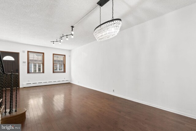 2225 S Hicks St, Philadelphia, PA 19145 - interior space featuring dark wood-style flooring, a textured ceiling, baseboards, baseboard heating, and an inviting chandelier