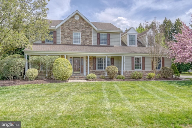 208 Grouse Trl, Camden Wyoming, DE 19934 - view of front of home featuring a front lawn, roof with shingles, a porch, and stone siding