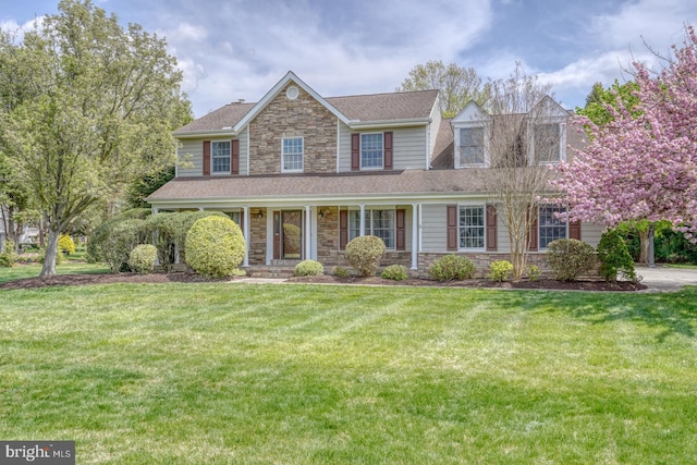 208 Grouse Trl, Camden Wyoming, DE 19934 - view of front of home featuring stone siding, a shingled roof, and a front lawn