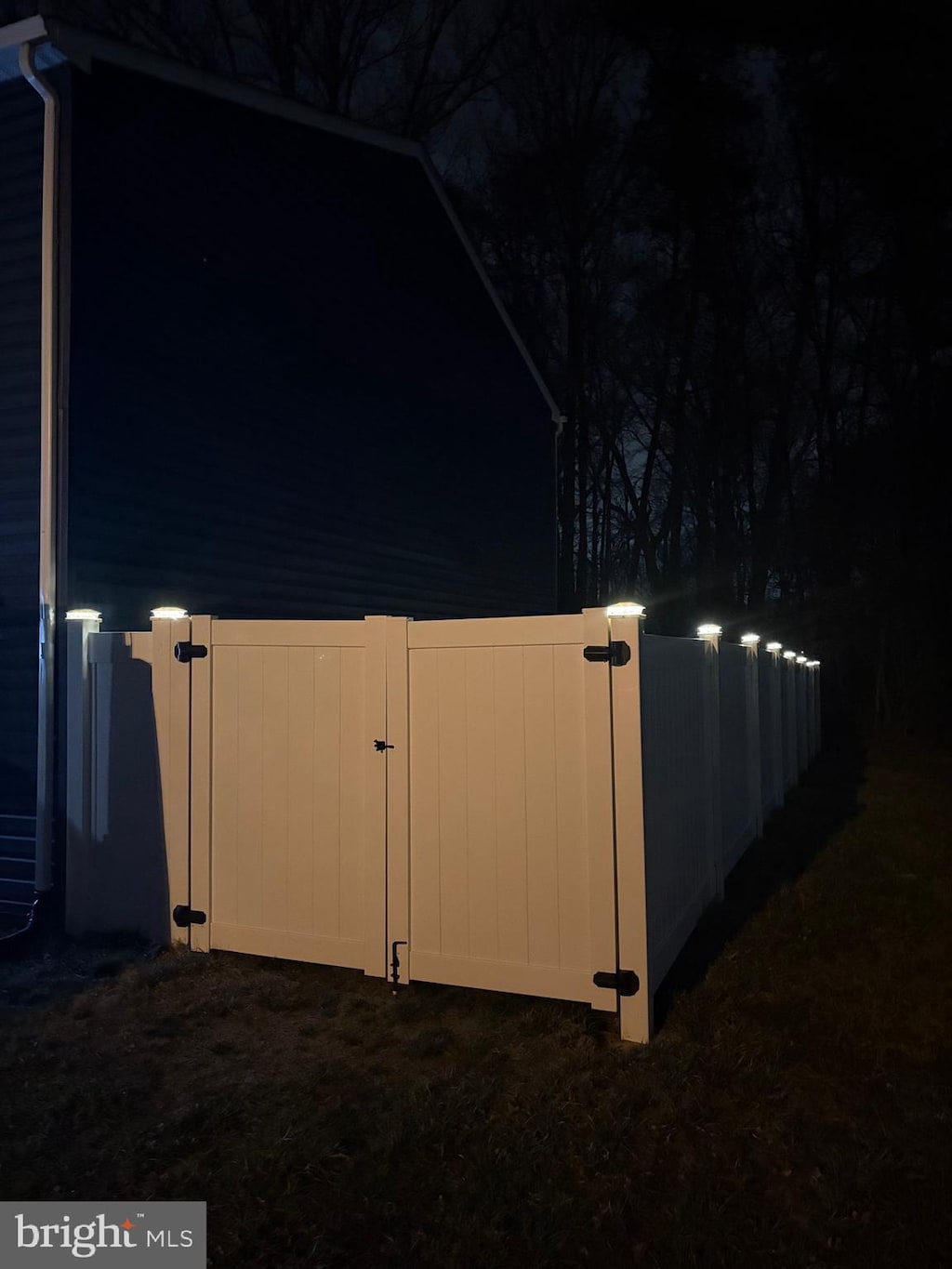 yard at twilight featuring a gate