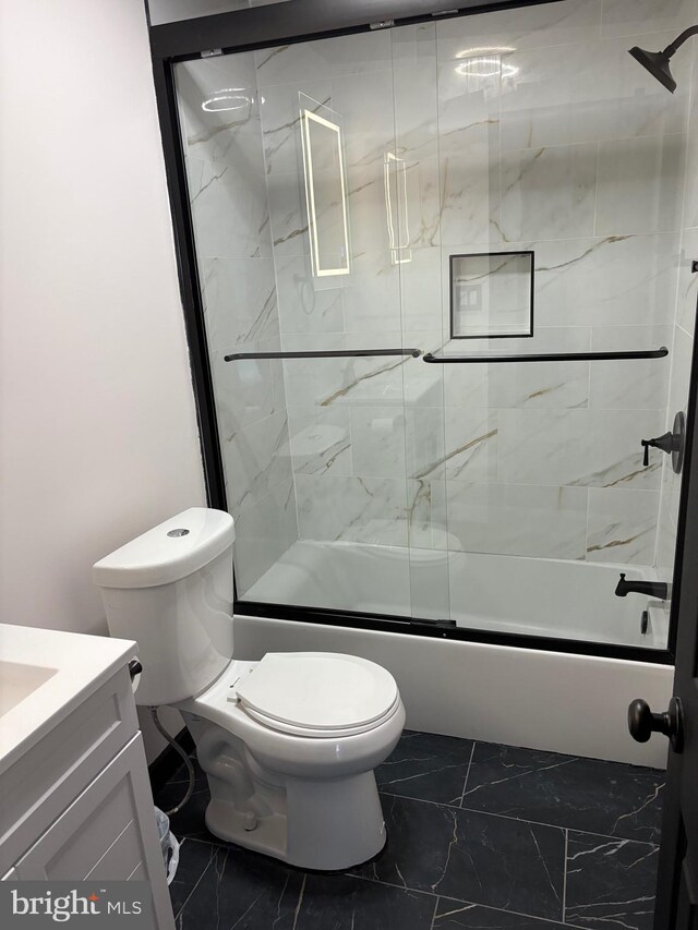 354 Kemper Dr, Newark, DE 19702 - bathroom with marble finish floors, vanity, toilet, and combined bath / shower with glass door