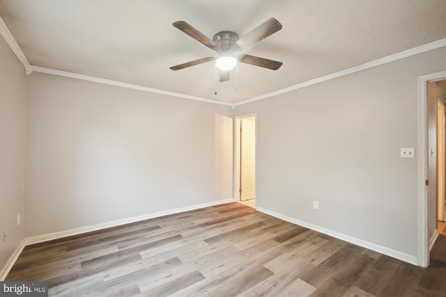 unfurnished room featuring wood finished floors, baseboards, ceiling fan, and crown molding