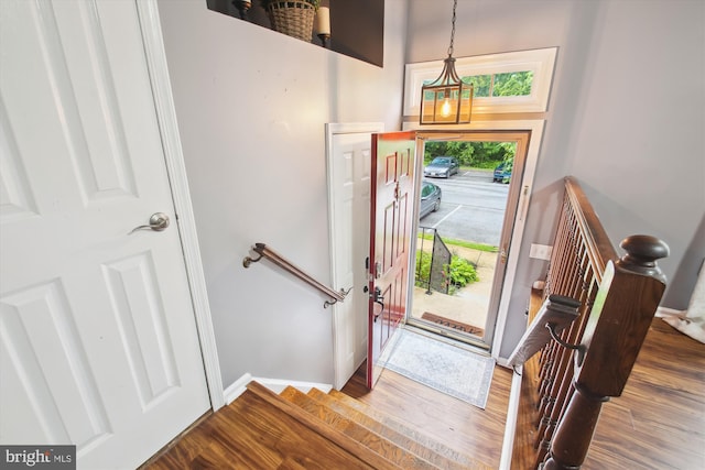 foyer featuring wood finished floors and baseboards